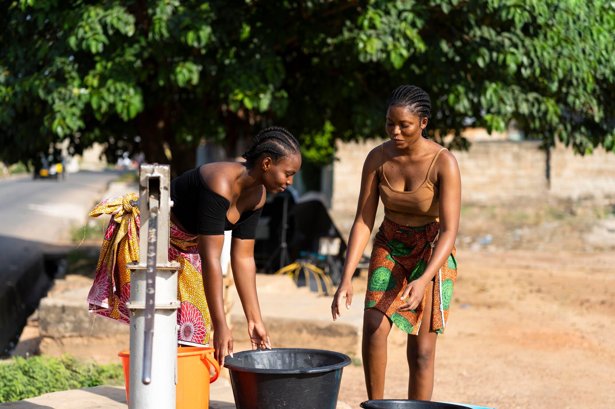 Community members drinking clean water from a new well