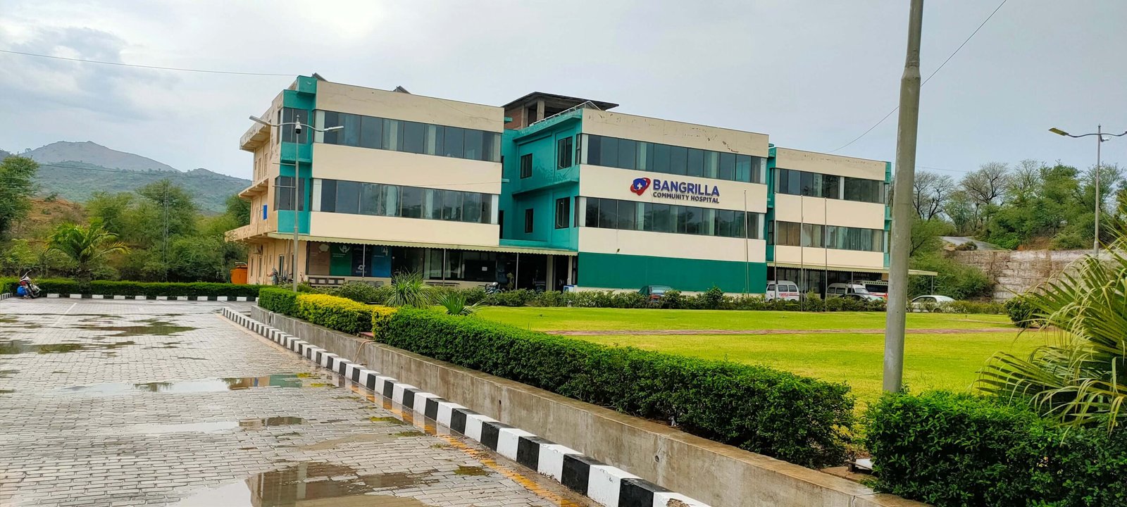 Side view of Bangrilla Community Hospital with Kashmir mountains in the background