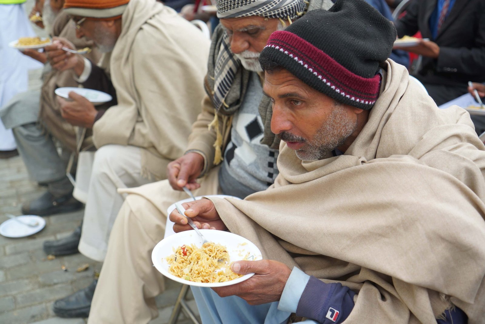 Elderly men sharing a meal at a community gathering