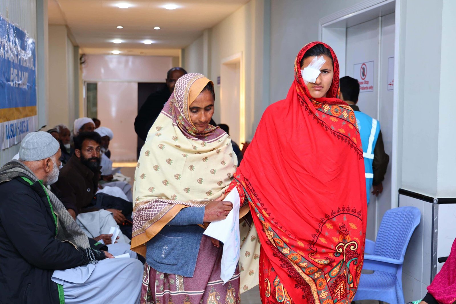 Post-operative patient being guided through the hospital with a companion