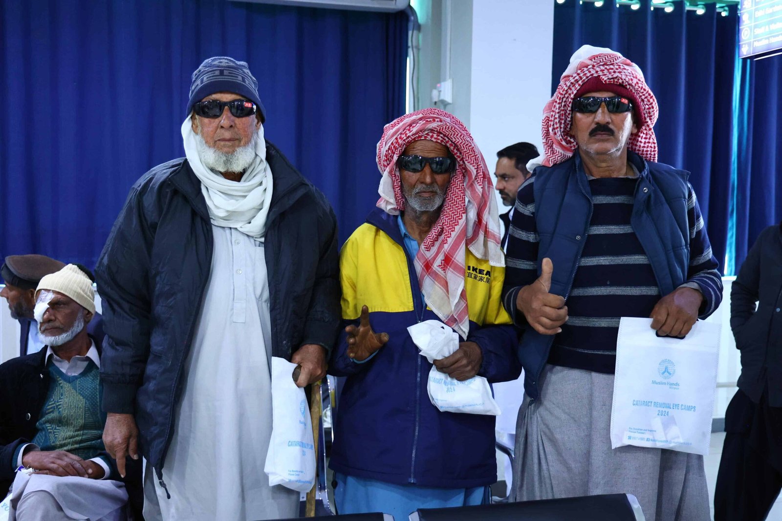 Three elderly patients recovering after successful eye surgery