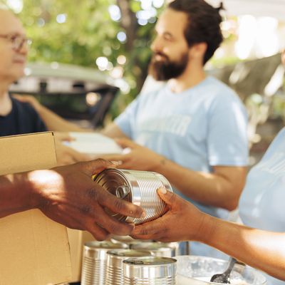 Volunteers preparing sadaqah food donation boxes